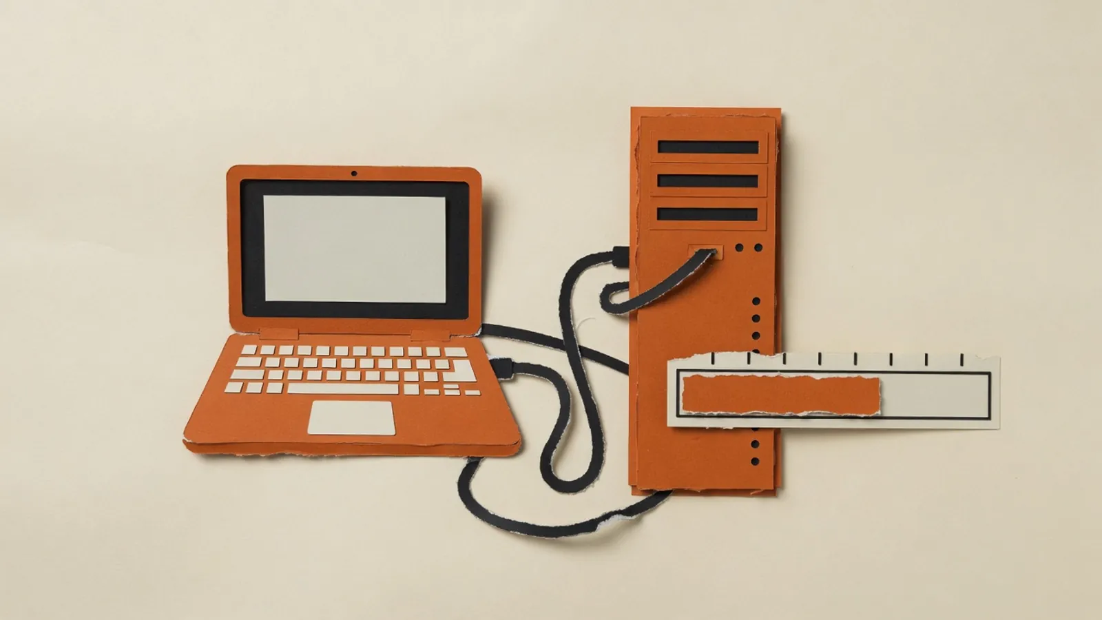 A laptop connected by a cable to a server tower, with a progress bar still filling.